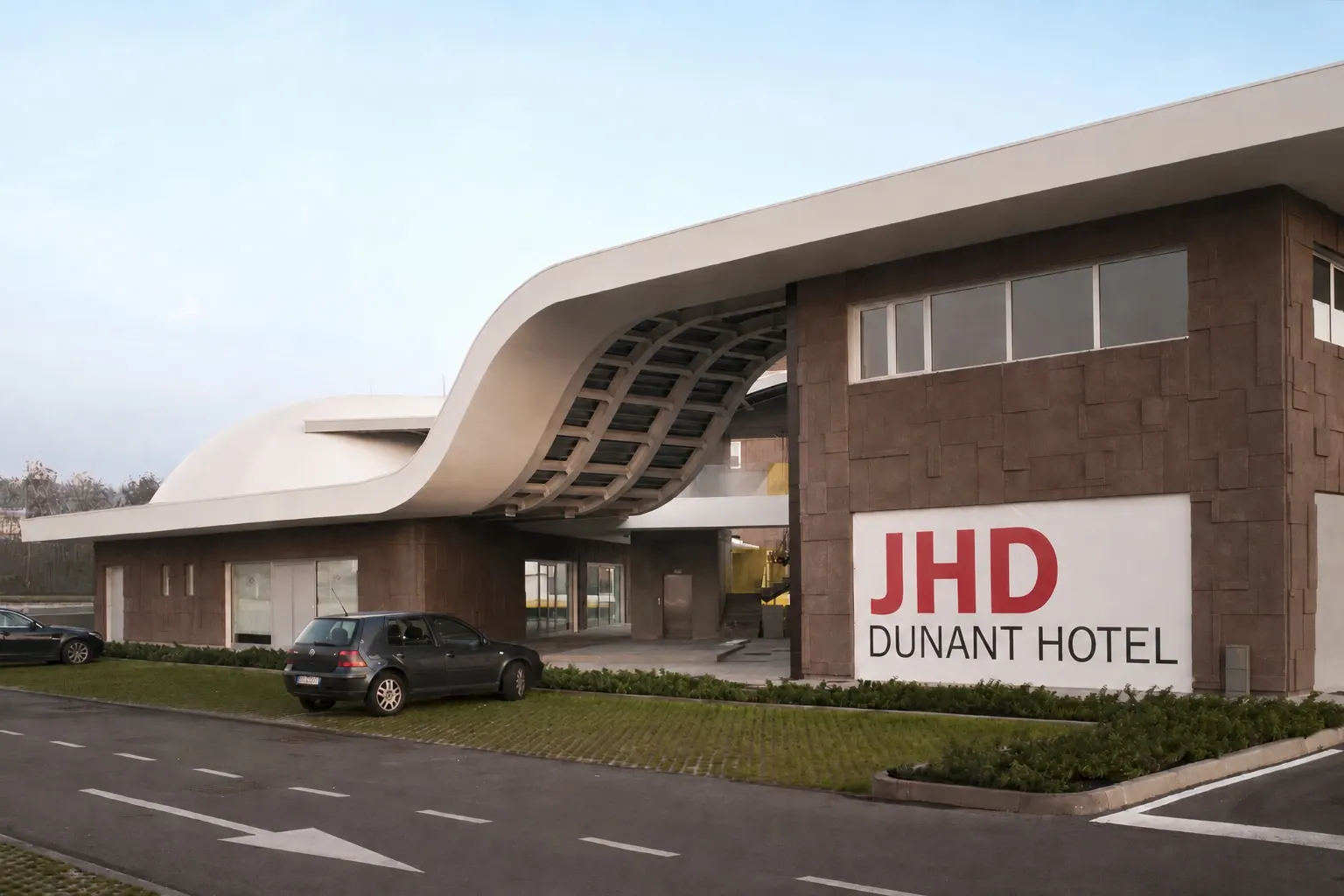 Ingresso dell'Hotel Dunant dalla strada: la pensilina bianca sinuosa sopra il percorso e il corpo a pannelli bruni con l'insegna