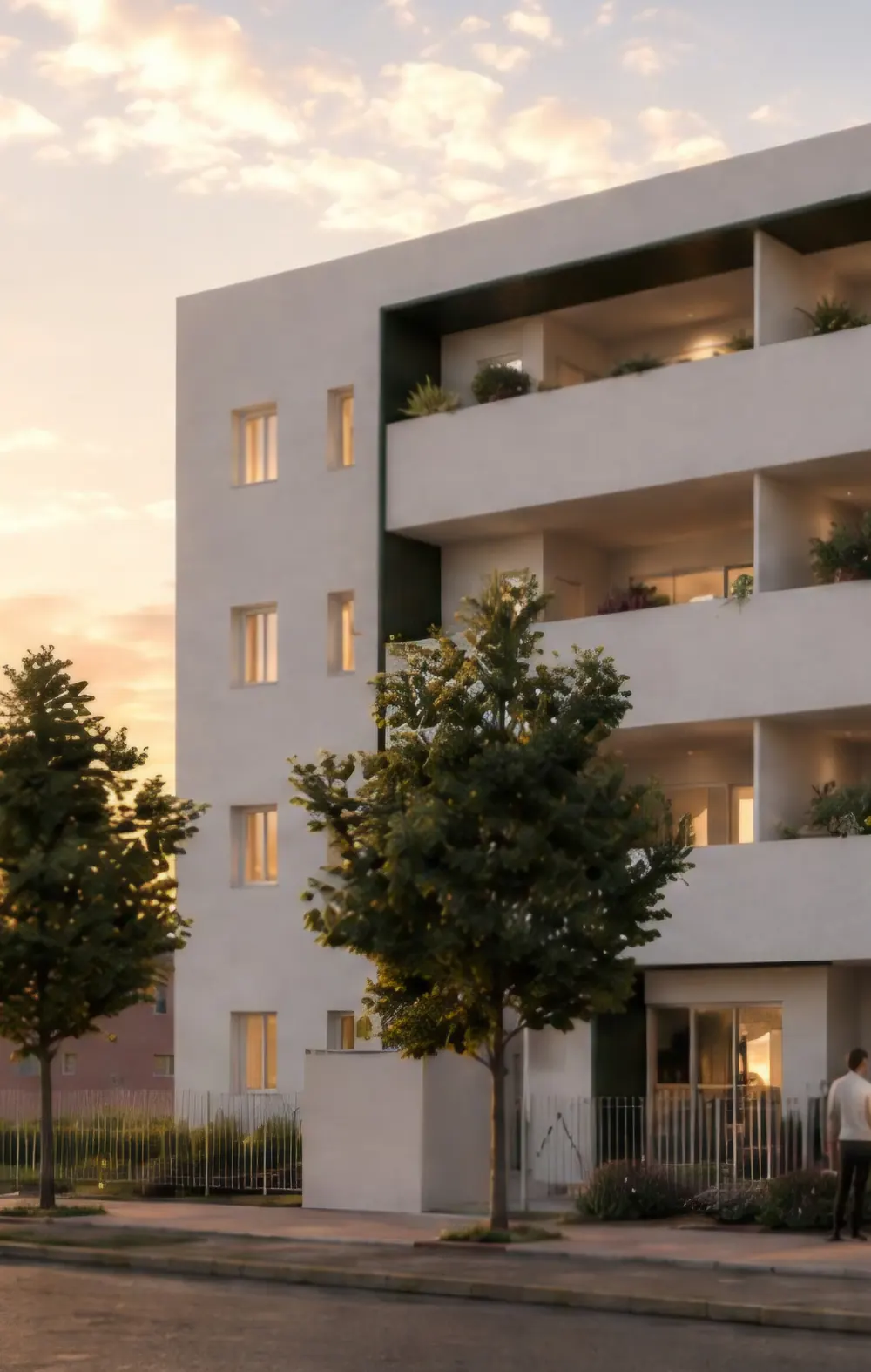 Palazzina residenziale di quattro piani con balconi profondi e finestre illuminate, al tramonto